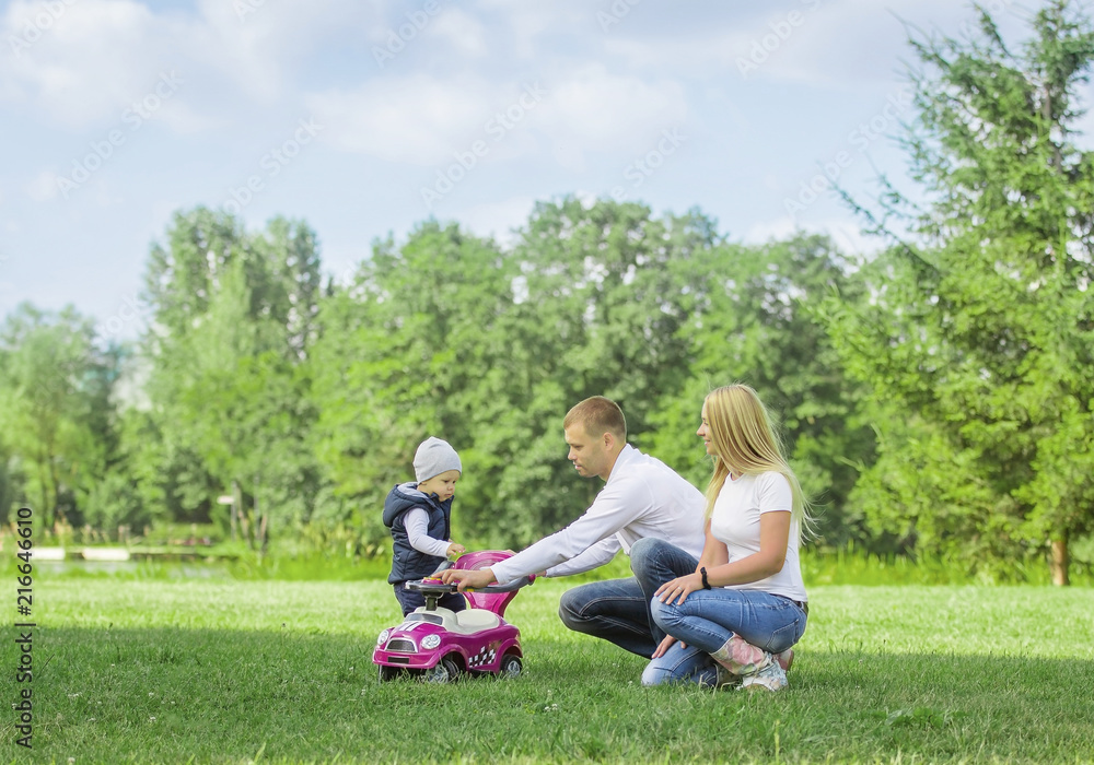 happy mom dad and son on a walk on a Sunny day