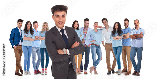 confident business leader standing in front of his casual team