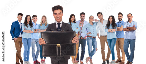 young businessman group leader offering you his suitcase