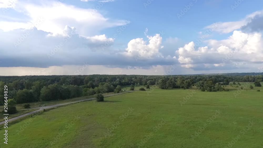 drone flies over the meadow and deciduous forest in the hilly terrain. drone flies over the meadow and deciduous forest in the hilly terrain.
