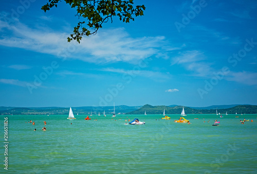 Tourists and sailboats on l...