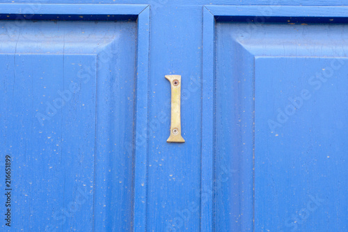 House number 1 sign on blue door