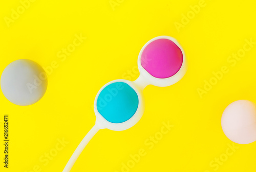 Color Kegel balls, Geisha balls in yellow background photo