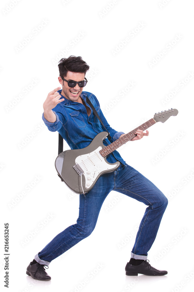 passionate guitarist making a rock and roll hand sign passionate guitarist making a rock and roll hand sign