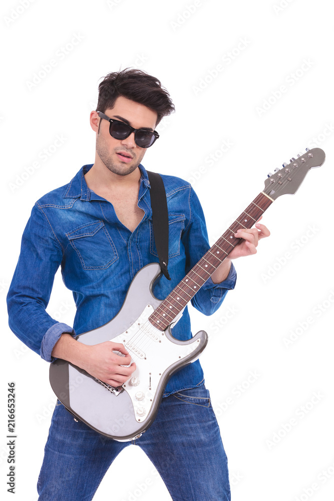 portrait of a young guitarist playing an electric guitar