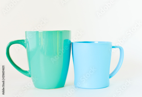 Ceramic and plastic mug isolated on white background. selective focus.