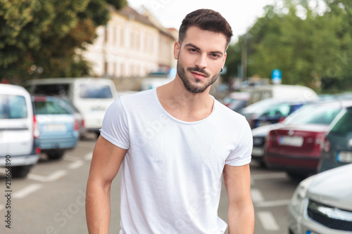 portrait of young casual man standing in a street