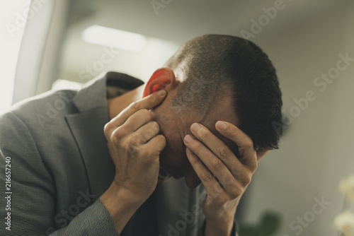suffering man with his hands in his head