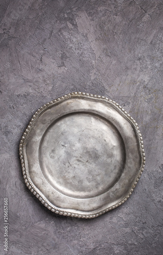 Vintage metal plate on gray plasterd background above