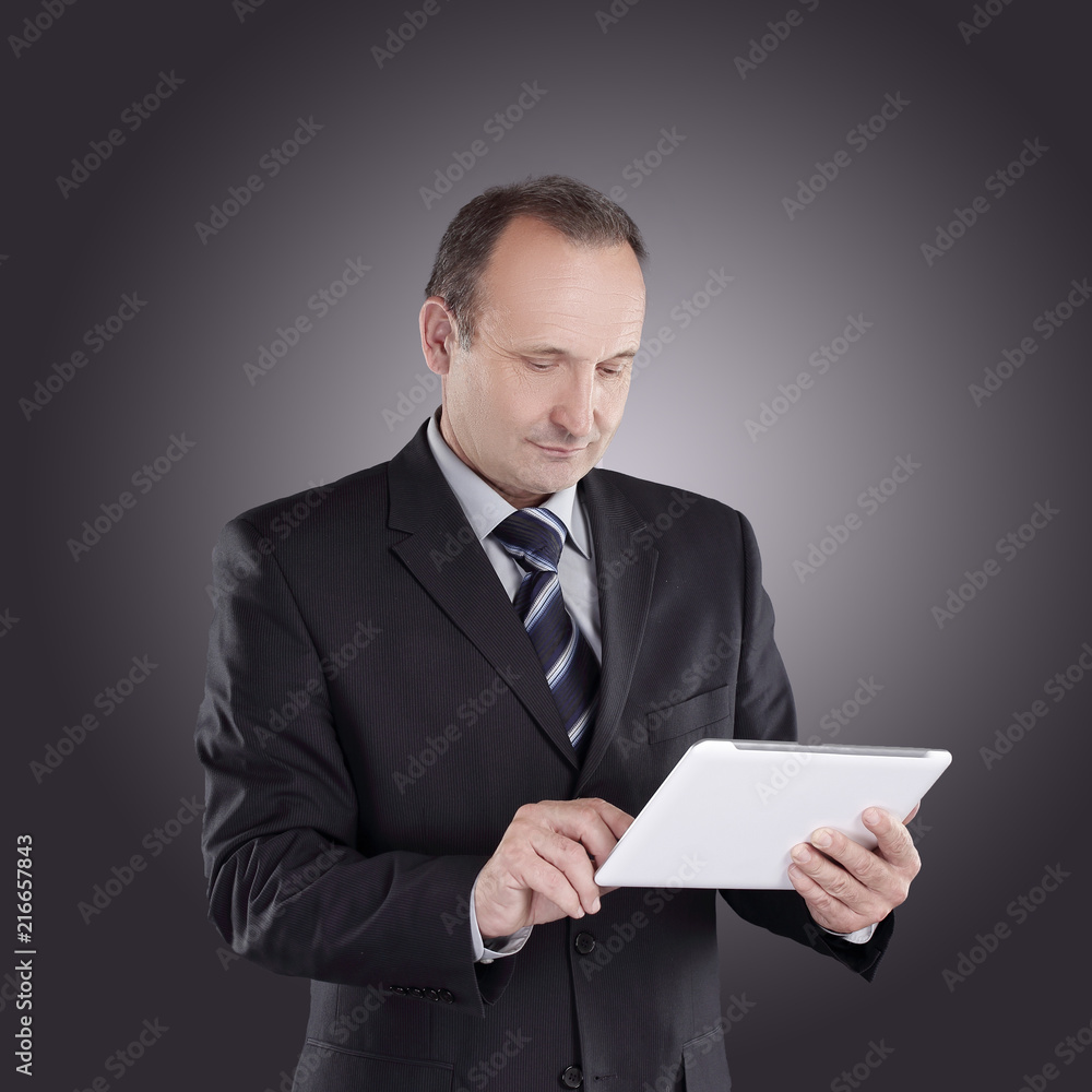 modern businessman with a digital tablet.isolated on black background modern businessman with a digital tablet.isolated on black background