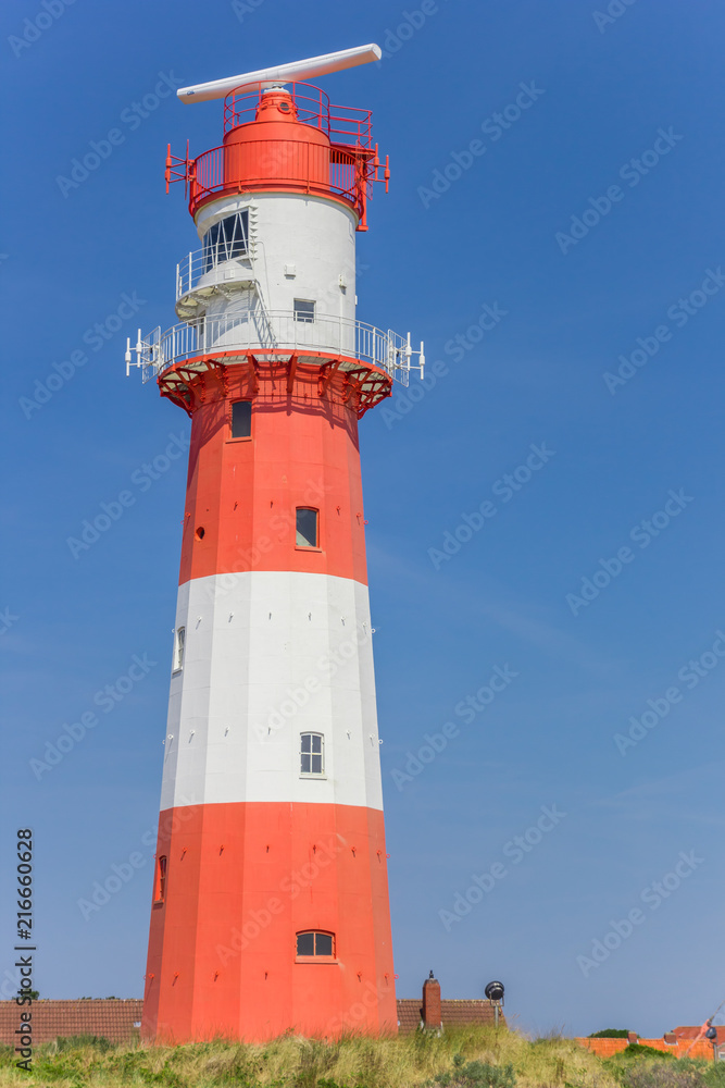 Colorful lighthouse on a dune in Borkum, Germany