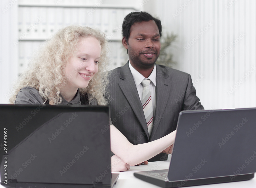 younger employees discussing business issues in office younger employees discussing business issues in office