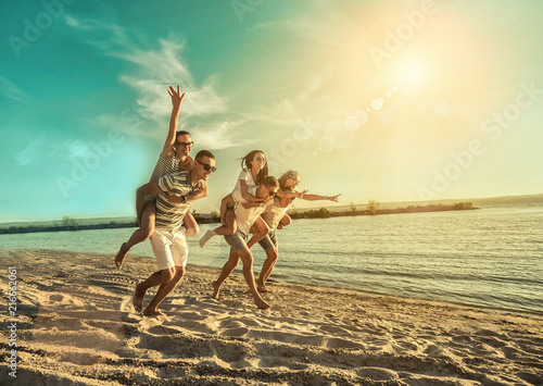 Happiness Friends fun on the beach under sunset sunlight in summer