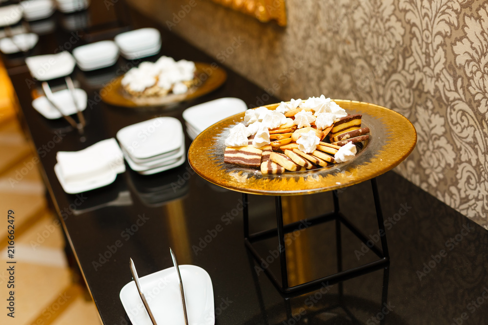 Delicious decorated candy bar, sweets on tables for wedding reception, catering in restaurant