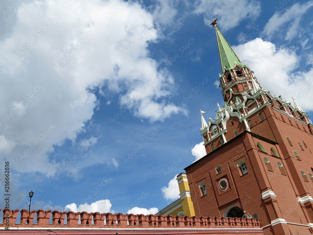 Moscow Kremlin tower with red star against the blue sky with white clouds. Troitskaya tower, russian architecture landmark
