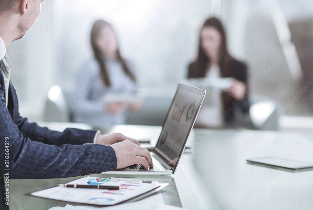 financial managers working on laptop with financial data at the workplace in a modern office financial managers working on laptop with financial data at the workplace in a modern office