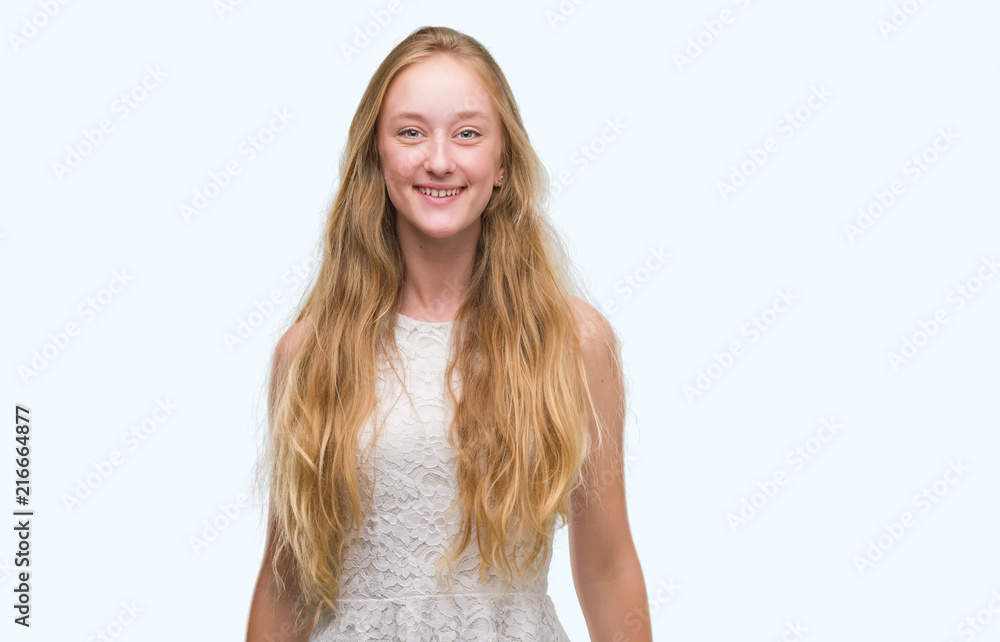Blonde teenager woman with a happy face standing and smiling with a confident smile showing teeth Blonde teenager woman with a happy face standing and smiling with a confident smile showing teeth