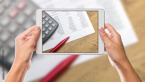 Hands holding tablet with office and calculator screen and white background