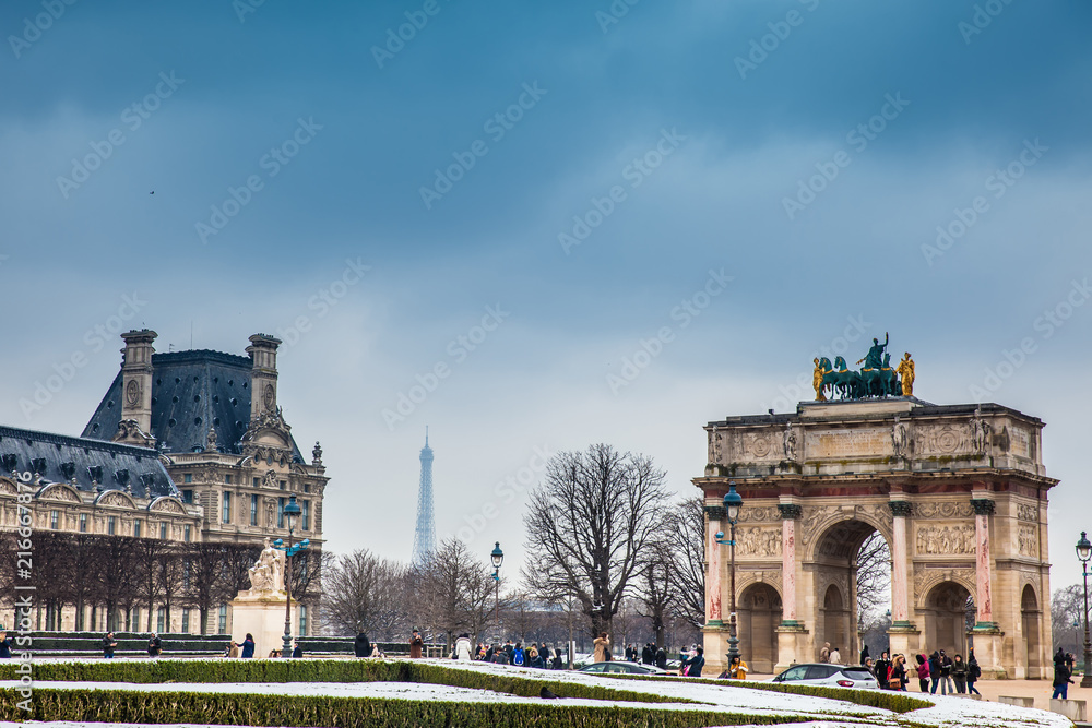 The Arch of Triumph, Louvre Museum and Eiffel Tower in a freezing winter day just before spring
