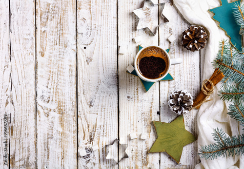 Cup of hot coffee with sugar and cinnamon on old wooden table with spruce branches. © Loraliu