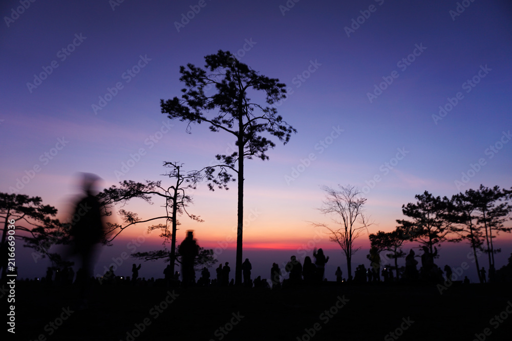 silhouette People walking and seeing sunrise on top of mountain