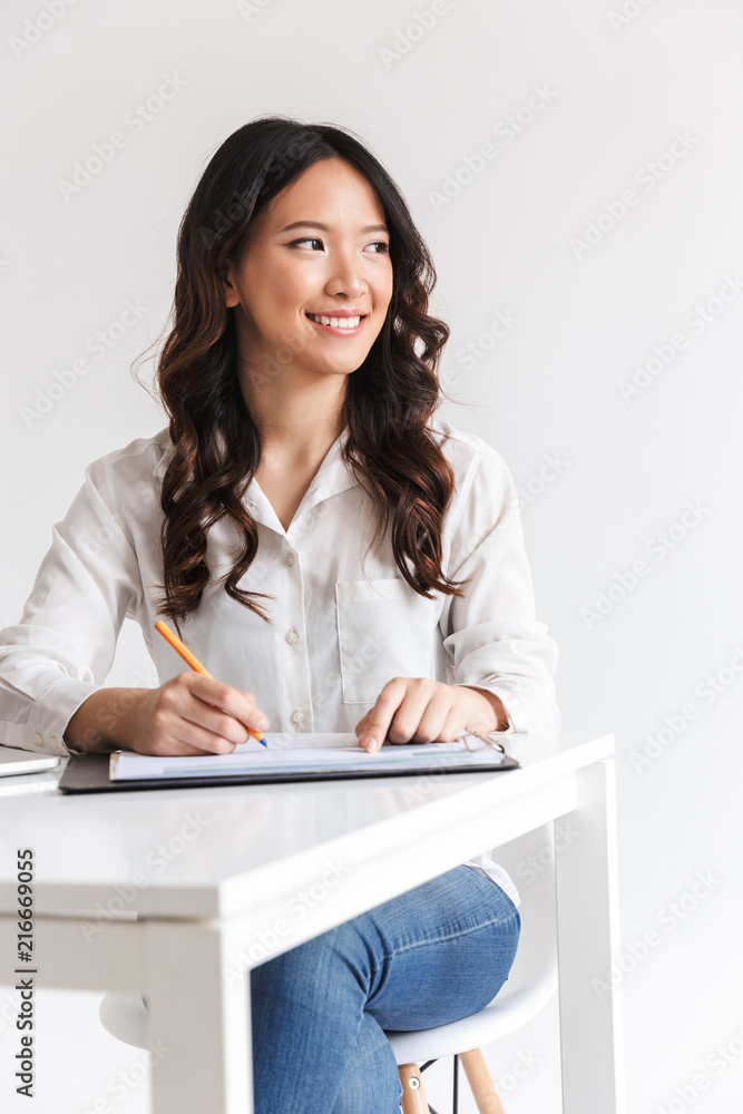 Attractive young asian businesswoman taking notes Attractive young asian businesswoman taking notes