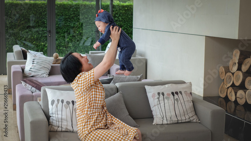 Mother and her lovely baby are very happy , living in the sweet home.