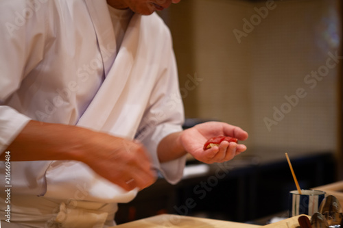 Professional sushi chef carefully using just the right pressure to make perfect sushi with confident and dedication. Precision and Finesse at its best practice to achieve top performance in business.