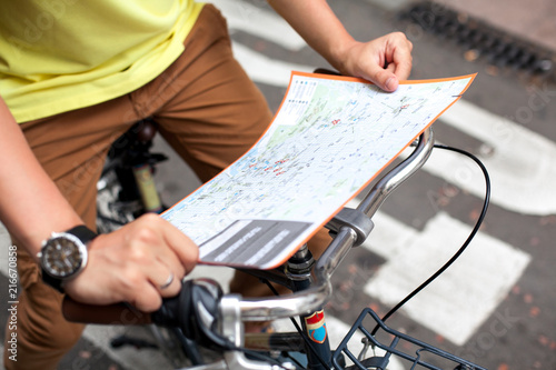 Male hands pointing on the map of Barcelona city on retro bicycle bike background.Tourism concept. Vacation.Holiday