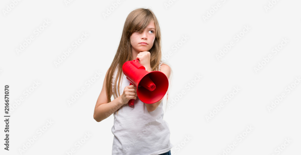 Young blonde toddler holding megaphone serious face thinking about question, very confused idea Young blonde toddler holding megaphone serious face thinking about question, very confused idea