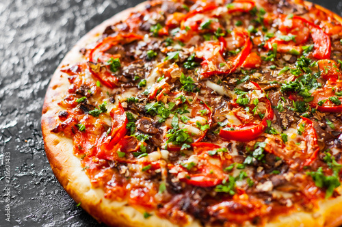 Pizza with Mozzarella cheese, mushrooms, Tomatoes, pepper, Spices and Fresh Basil. Italian pizza.