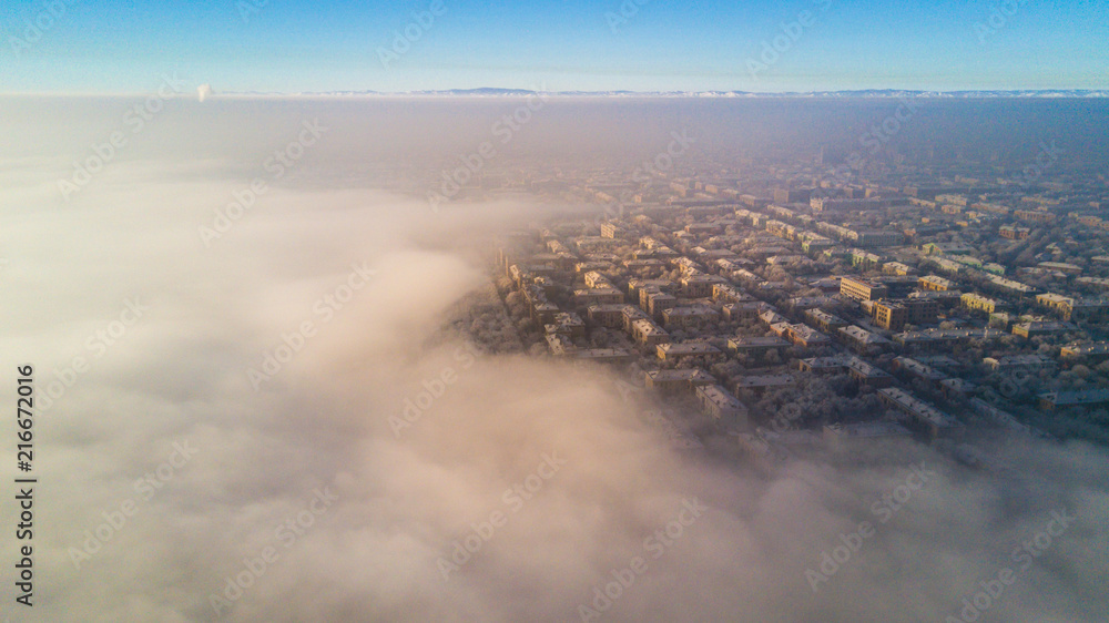 Aerial photo of city Magnitogorsk with the looming fog in the winter evening, Low lying cloud over the city Aerial photo of city Magnitogorsk with the looming fog in the winter evening, Low lying cloud over the city