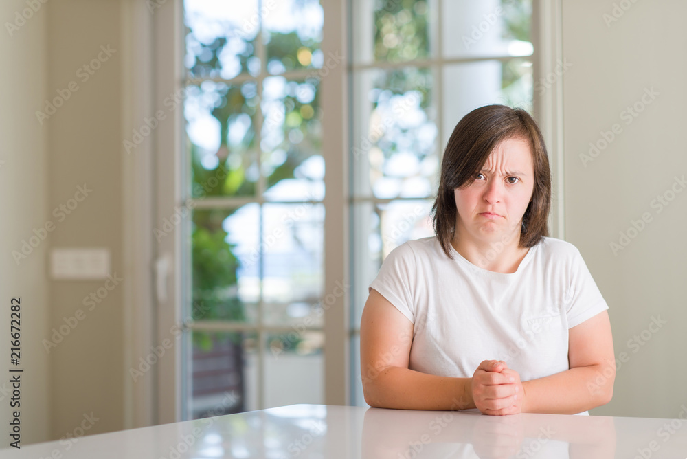 Down syndrome woman at home depressed and worry for distress, crying angry and afraid. Sad expression. Down syndrome woman at home depressed and worry for distress, crying angry and afraid. Sad expression.