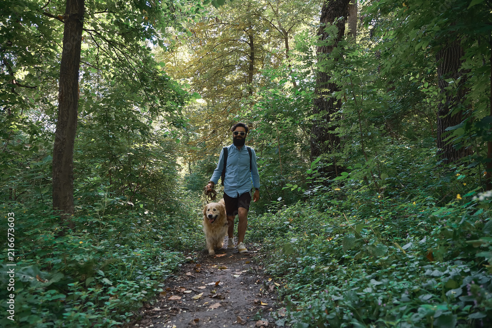 Obraz premium Handsome man walking his dog in outdoors