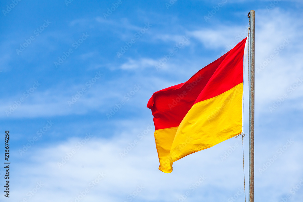 Red and yellow warning flag on a beach Red and yellow warning flag on a beach