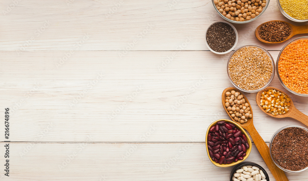 Cereals and legumes assortment on wooden table Cereals and legumes assortment on wooden table
