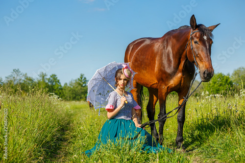 beautiful girl in a beautiful dress standing next to the horse © Екатерина Переславце