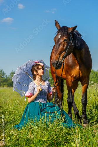 beautiful girl in a beautiful dress standing next to the horse
