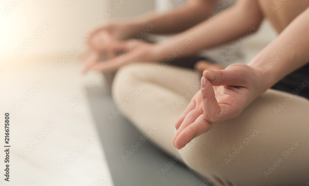 Young couple meditating together in studio Young couple meditating together in studio