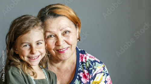 Grandma kisses her beloved granddaughter on the cheek