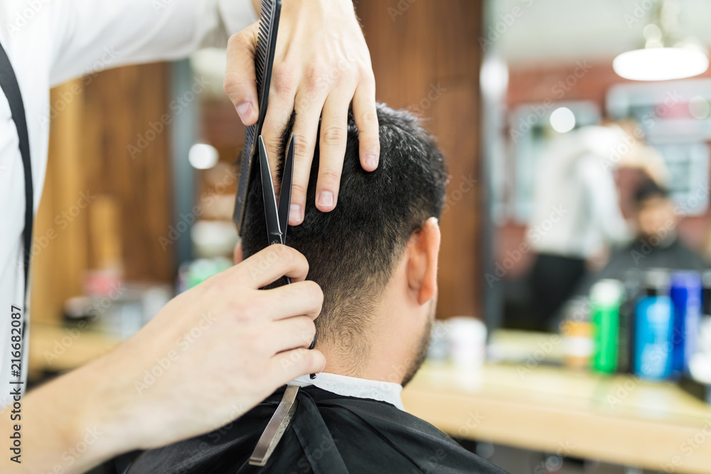 Male Expert's Hands Using Scissors To Cut Client's Hair Male Expert's Hands Using Scissors To Cut Client's Hair