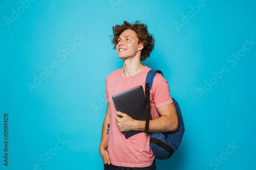 Foto Image of attractive youngster guy with curly hair wearing casual clothing and ba