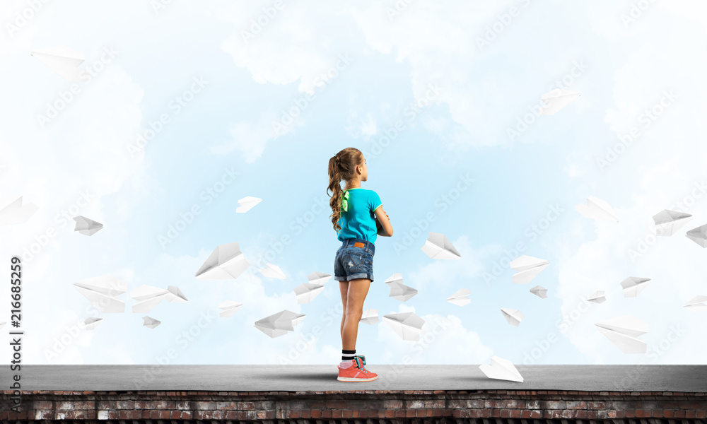 Concept of careless happy childhood with girl looking far away Concept of careless happy childhood with girl looking far away
