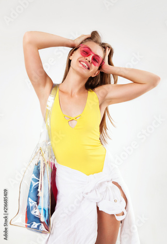 Beautiful summer girl in yellow swimwear with a big bag