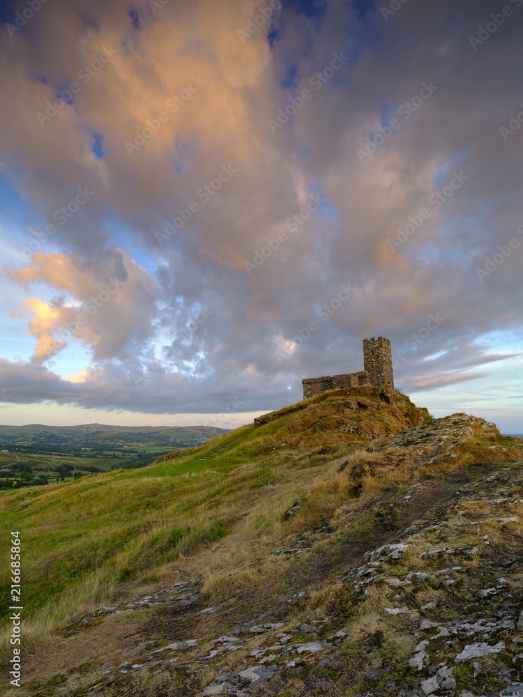 Summer sunset over Brentor, with the church of St Michael de Rupe - St Michael of the Rock, on the edge of the Dartmoor National Park, Devon, UK