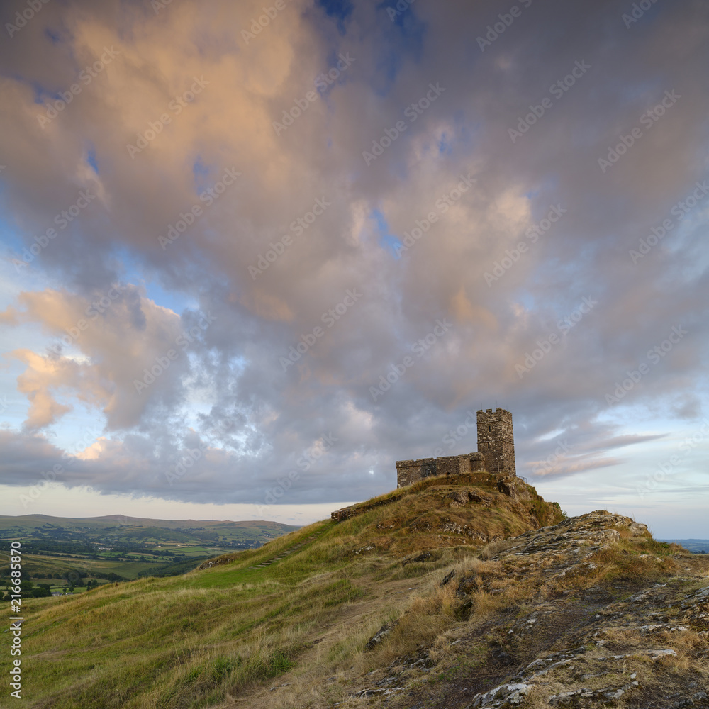 Summer sunset over Brentor, with the church of St Michael de Rupe - St Michael of the Rock, on the edge of the Dartmoor National Park, Devon, UK Summer sunset over Brentor, with the church of St Michael de Rupe - St Michael of the Rock, on the edge of the Dartmoor National Park, Devon, UK