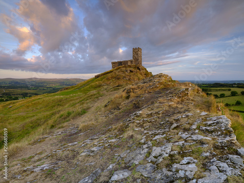 Summer sunset over Brentor  with the church of St Michael de Rupe - St Michael of the Rock  on the edge of the Dartmoor National Park  Devon  UK