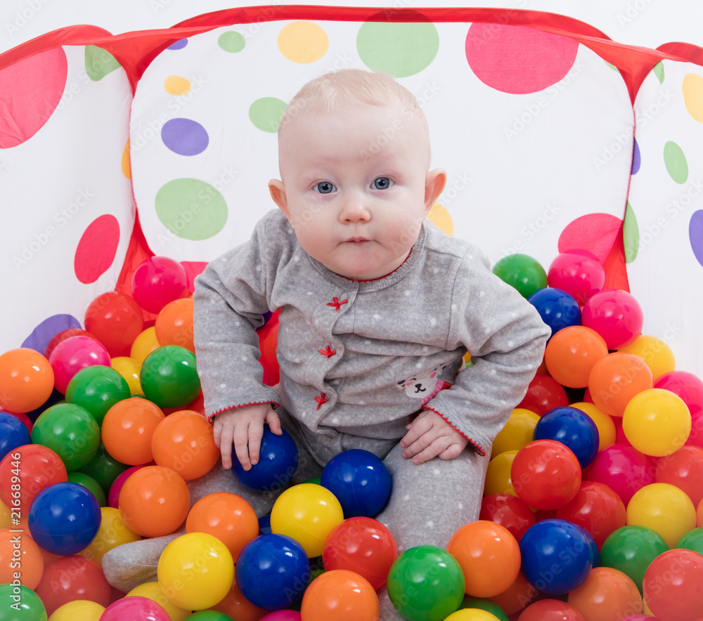 Baby playing with balls in the playground Baby playing with balls in the playground