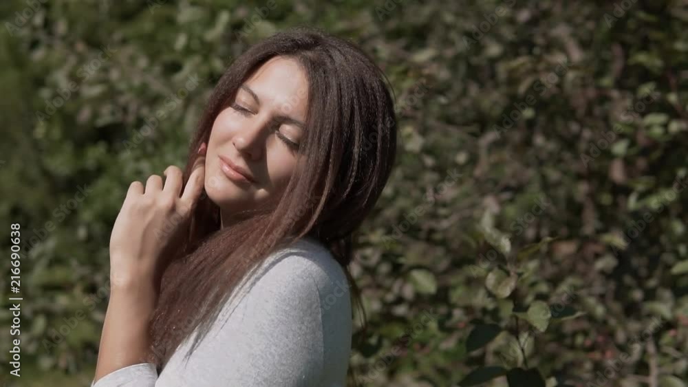 Beautiful girl posing in the park. slow motion. Portrait Beautiful girl posing in the park. slow motion. Portrait