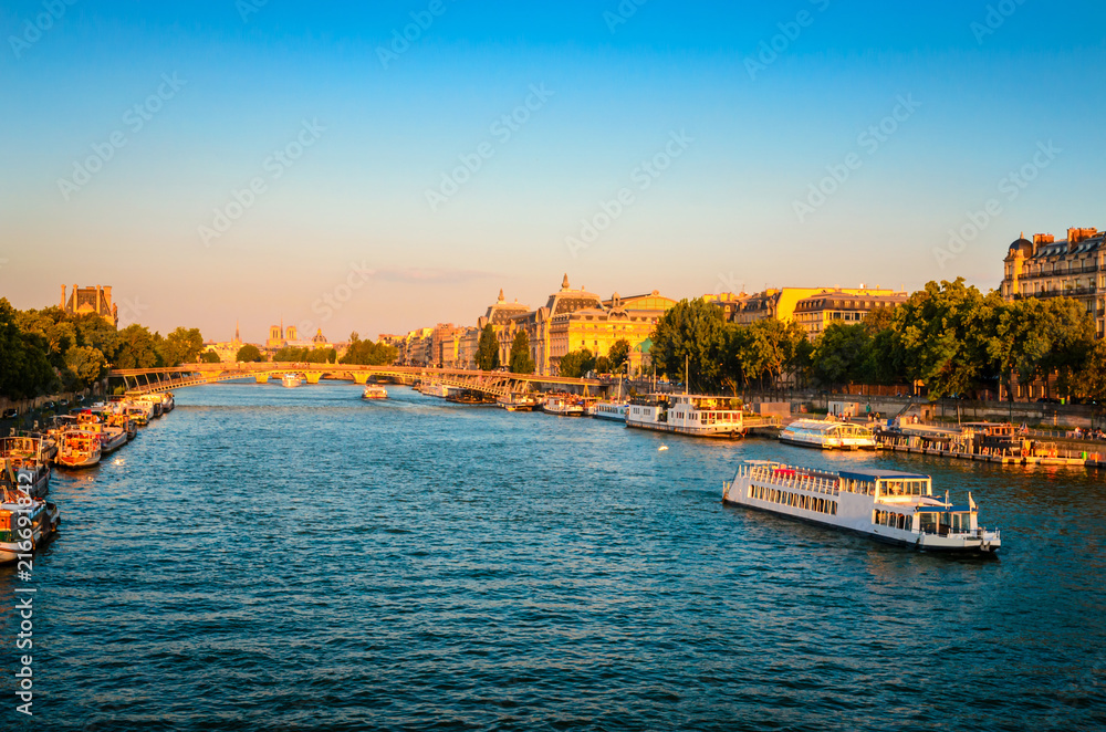Sunset view on bridge and buildings on the Seine river in Paris, France